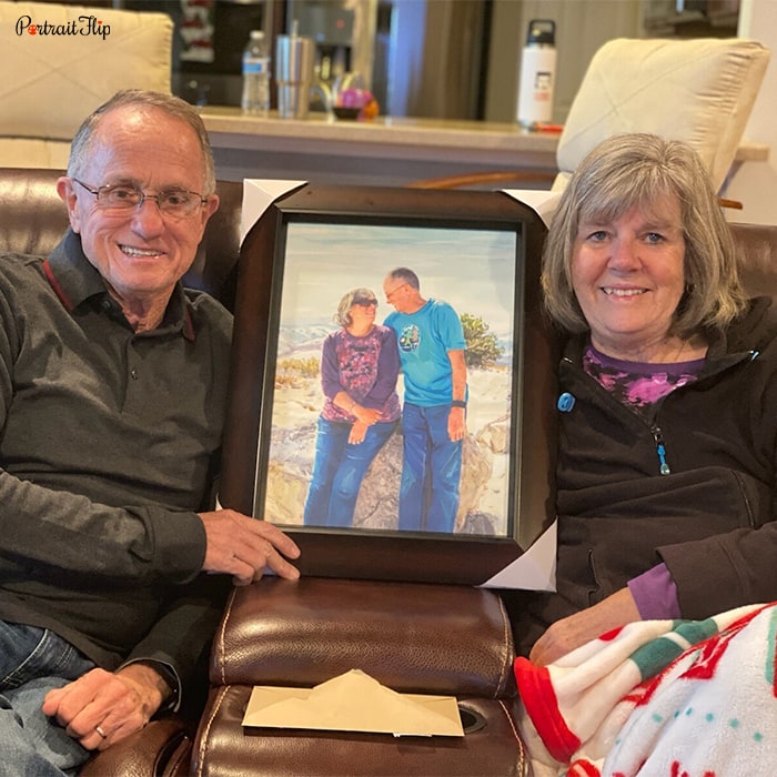 Picture of an old man and woman sitting on couch with anniversary portraits in between that show them sitting on a rock