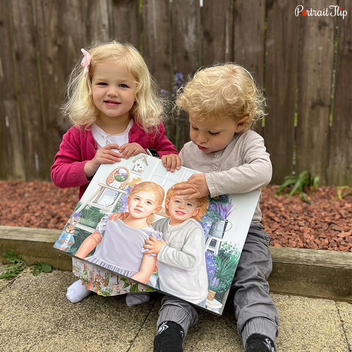 Picture of two babies, one boy and one girl, sitting on a sidewalk holding baby portraits in their hands