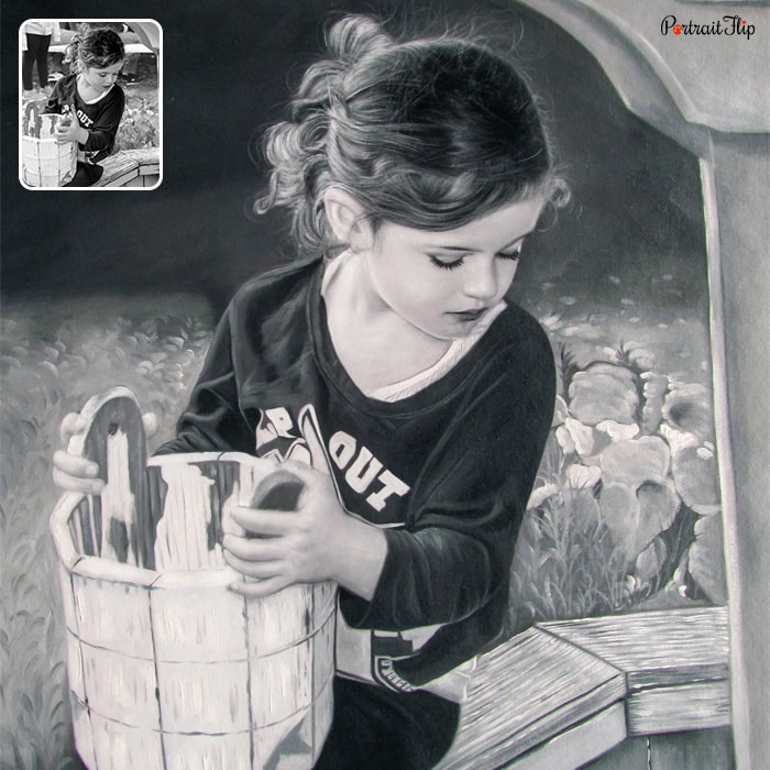 Black and white picture of a young girl holding a bucket in her hands