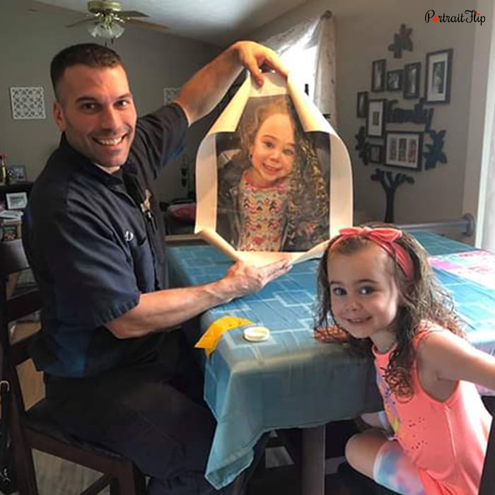 Picture of a man holding a painting that shows a young girl