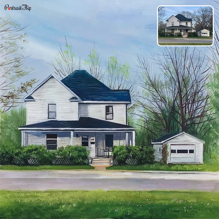 House portraits of a white-blue house in the side of the road with trees around it