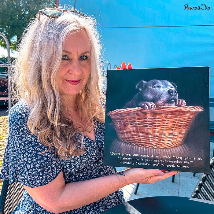 Happy customer holding a pet memorial portrait