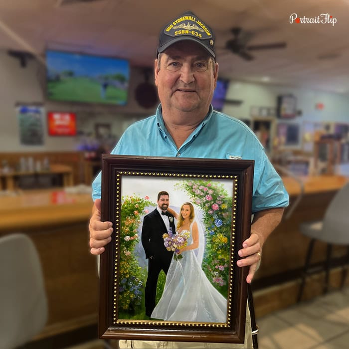 Man holding a custom wedding portrait painting