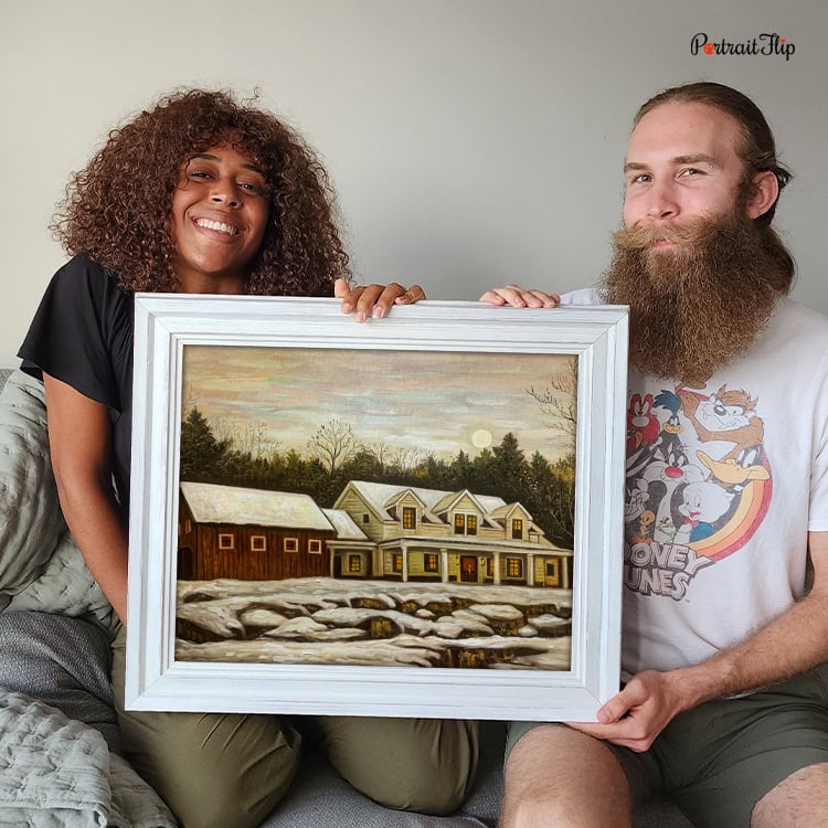 Couple holding a framed custom impasto house portrait painting