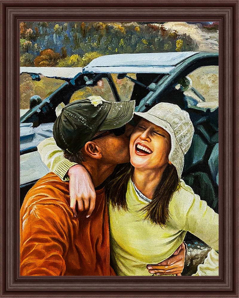 Framed oil painting of a couple on an off-road ride, the man kissing the laughing woman's cheek